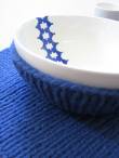 A woolen rollneck embraces Liisa Dudgeon's bowl in the Clothing for Crockery collection