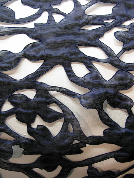 Fabric is shrunk, has cut outs and cording endings, Trevira CS shiny yarns